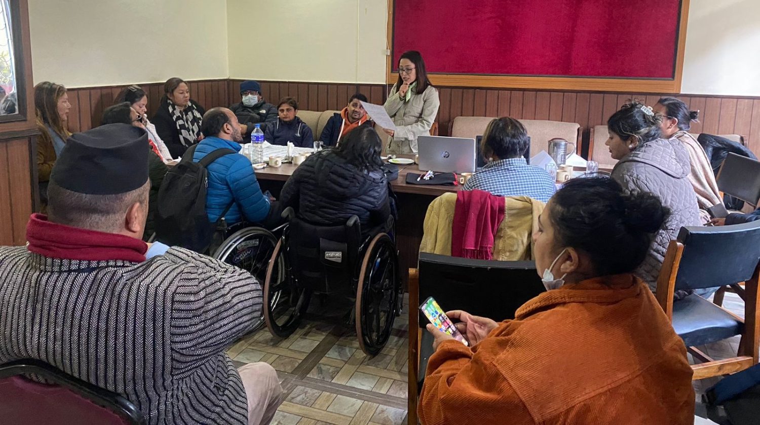 Participants sitting round table and dr Sunita maleku presenting points from the group discussion