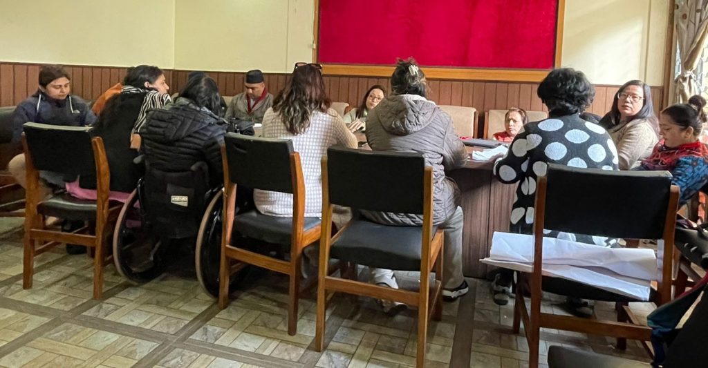 Participants sitting round table and discussing.
