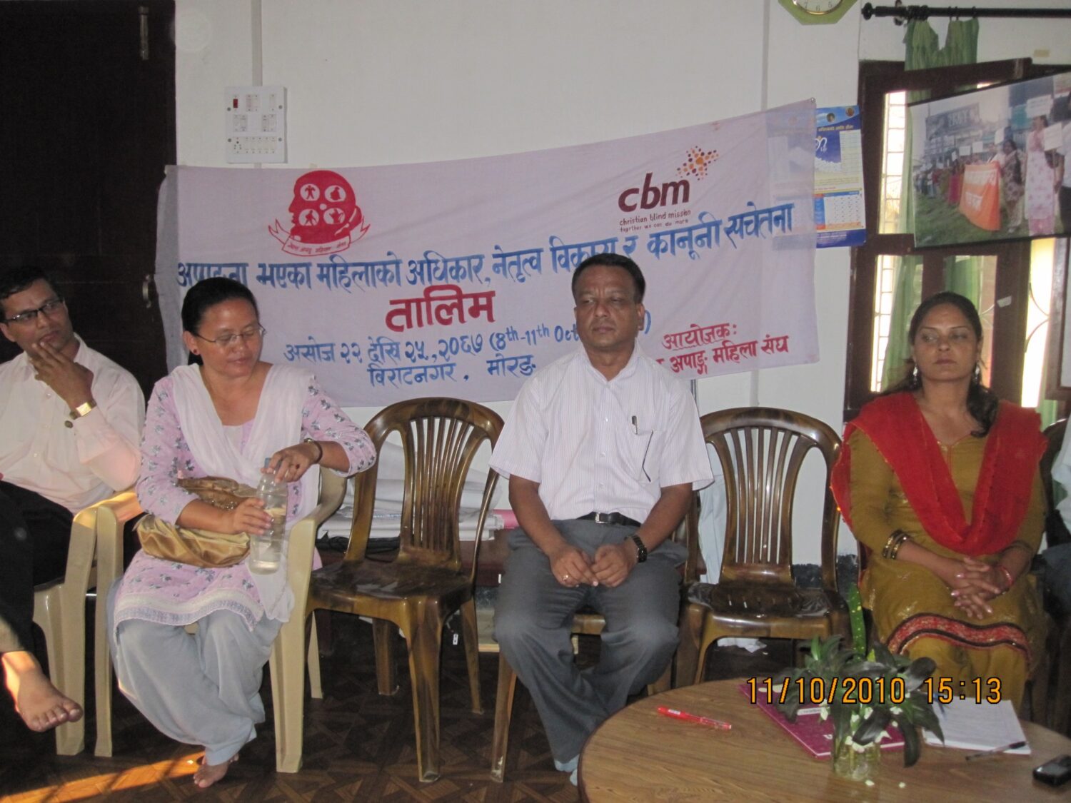 There is a banner reads its a training on rights, leadership and legal awareness among women with disabilities in Morang. There are 4 people siting on chair, facing the camera.