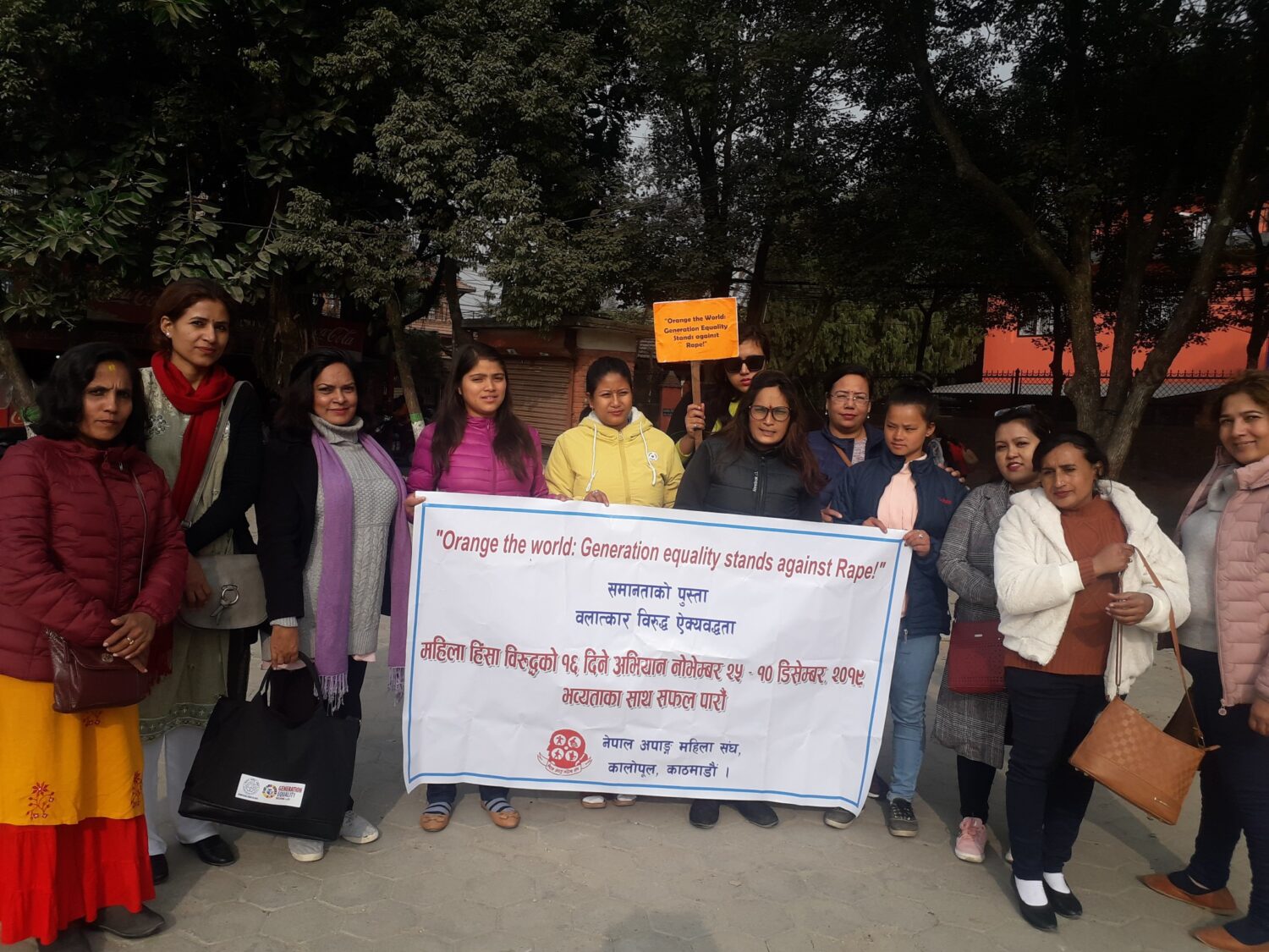 A group of women carrying a banner on the occasion of 16 days of activism against gender-based violence.