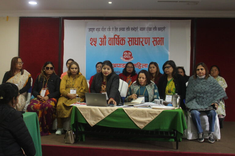 The board members are sitting on the dais. The General Secretary is addressing the participants. There is a banner that reads 25th Annual Review Meeting 2025.