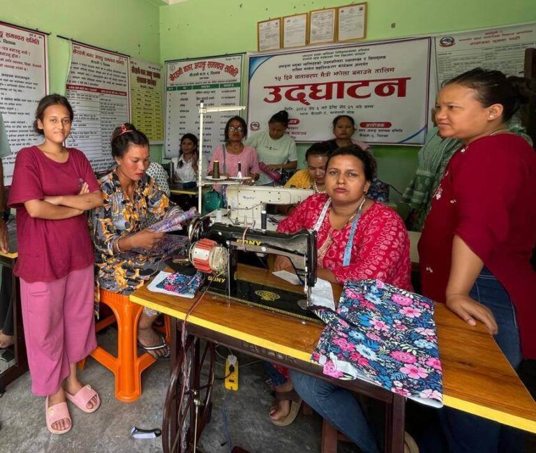The picture is of a woman who got financial support by FAIDA project. A woman with physical disability is using a sewing machine and sewing a cloth.