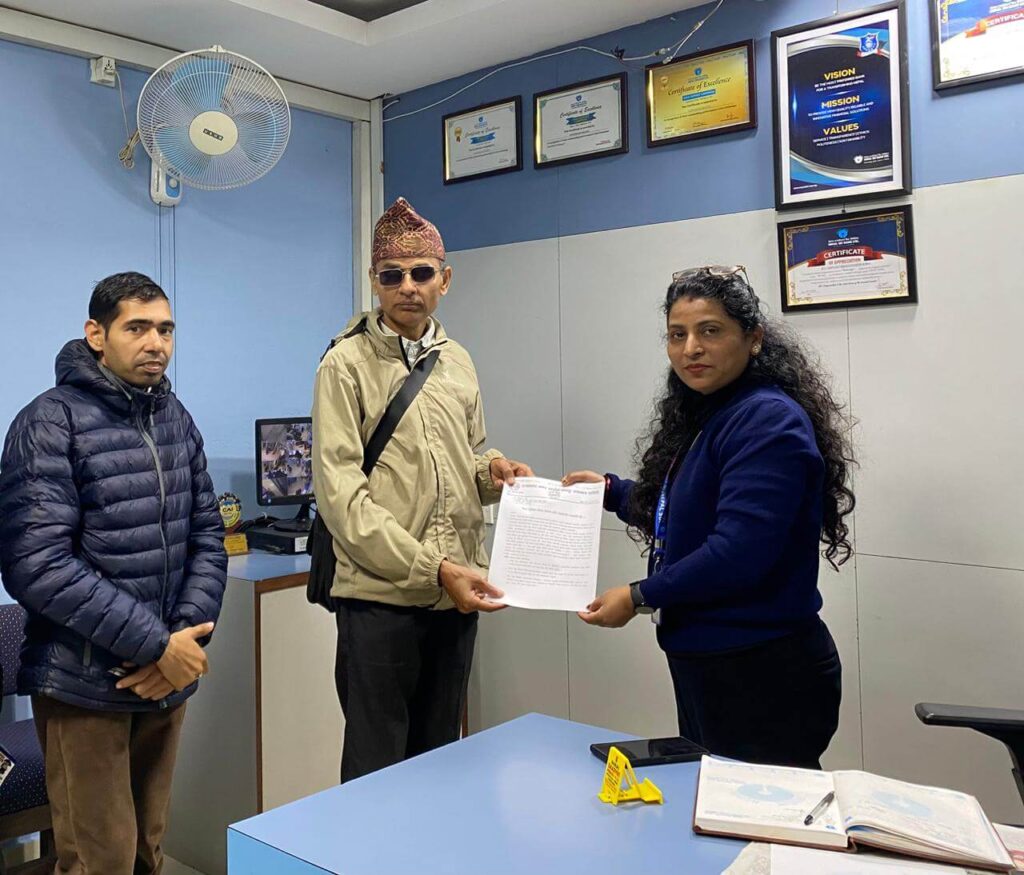 Mr Minraj Khanal is presenting the memorandum and attention letter to the branch manager of Nepal SBI Bank, Tandi, Chitwan.